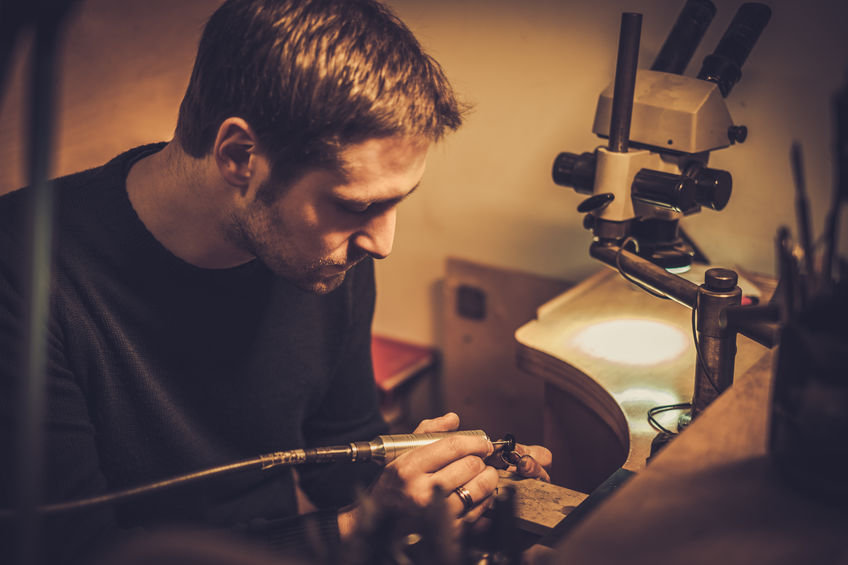 Jeweler at work in jewelery workshop