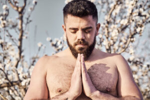 shirtless man meditating in spring garden 2026 01 09 09 14 20 utc